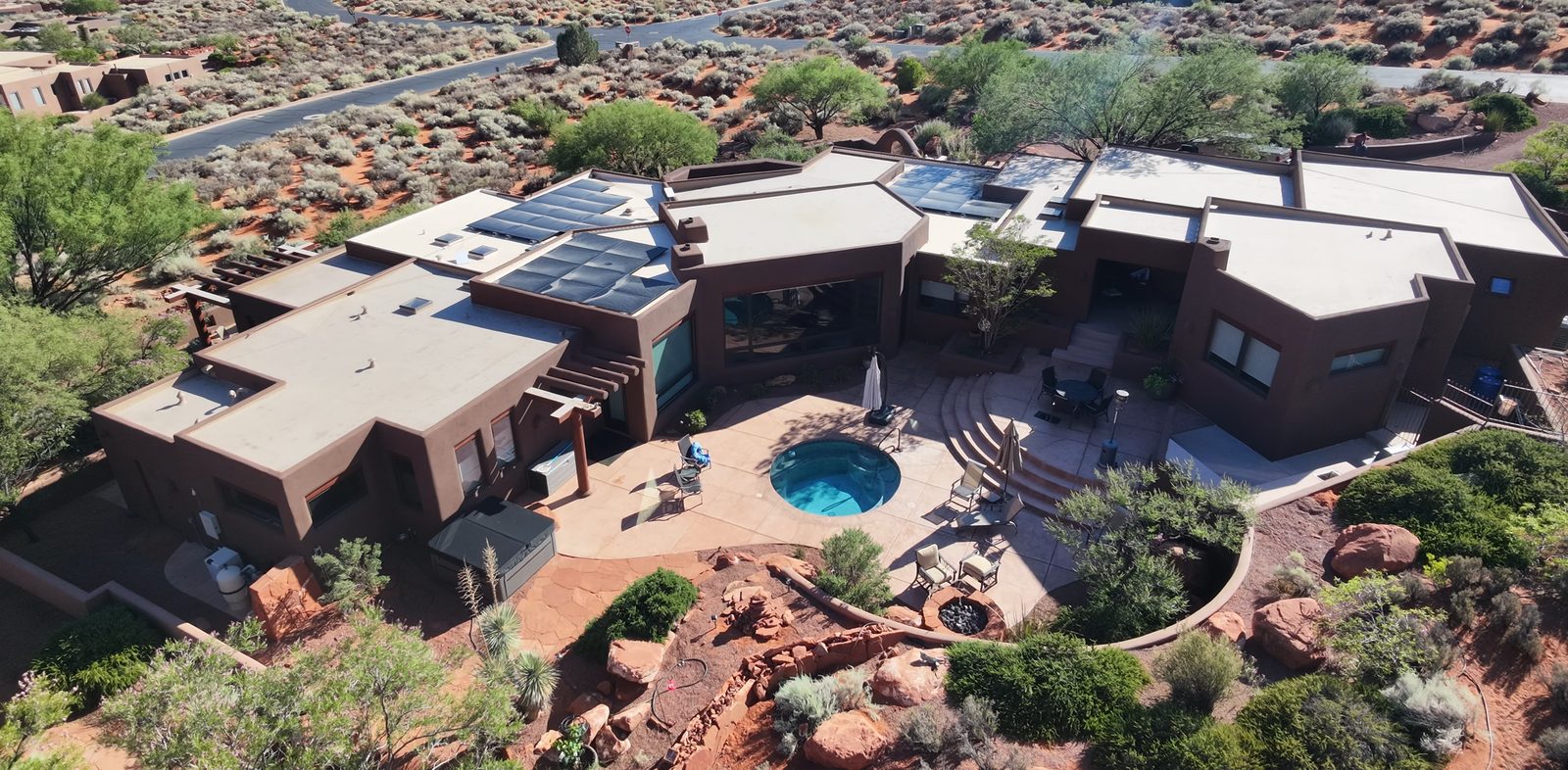 Backyard with a pool, fire bowls and a stone patio, today