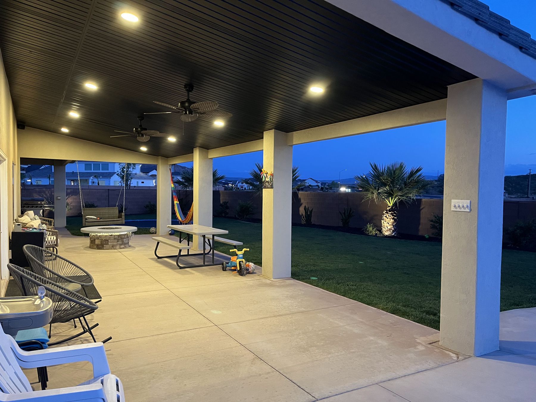 A covered outdoor living area lit at night